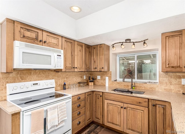 kitchen with a sink, decorative backsplash, white appliances, and light stone countertops