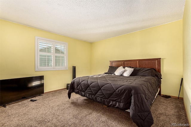 bedroom featuring carpet flooring, baseboards, and a textured ceiling