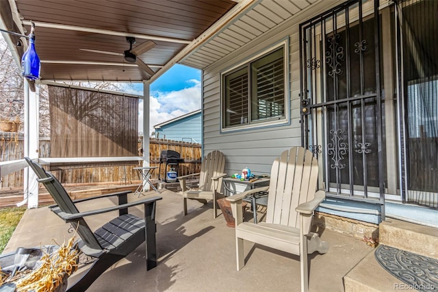 view of patio featuring a ceiling fan and fence