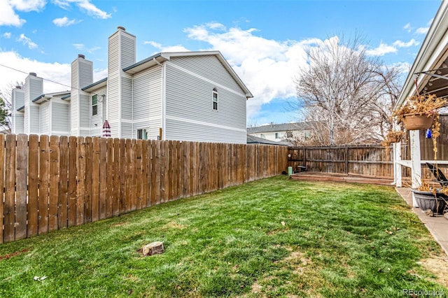 view of yard with a fenced backyard