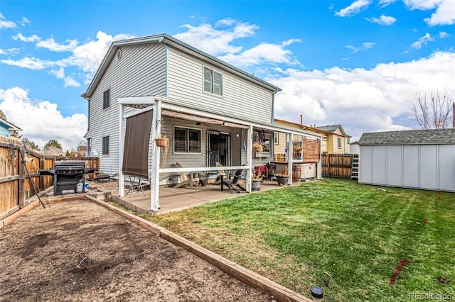 back of property with a yard, a fenced backyard, an outdoor structure, a storage unit, and a patio area