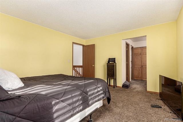 bedroom with a textured ceiling, baseboards, and carpet floors