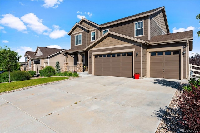 craftsman-style house featuring a garage and driveway