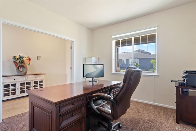 office with light carpet and baseboards