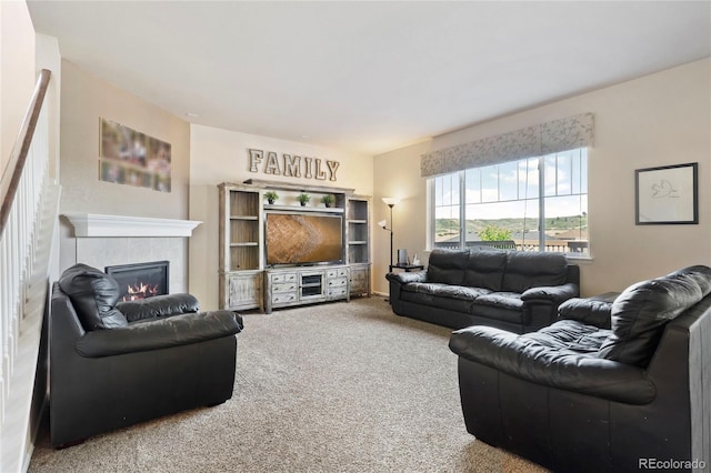 living room with a fireplace and carpet