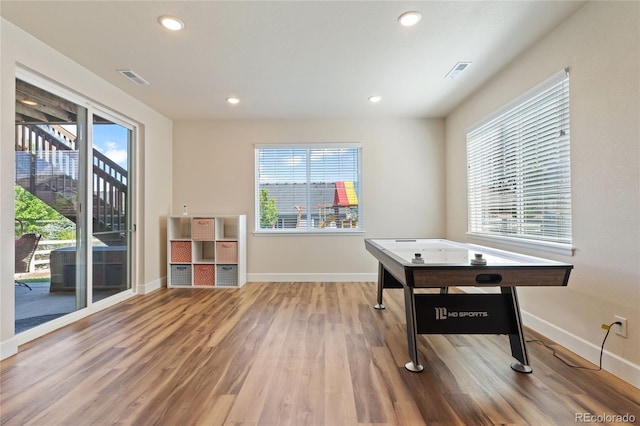 recreation room featuring recessed lighting, visible vents, baseboards, and wood finished floors