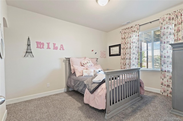 carpeted bedroom featuring baseboards and visible vents