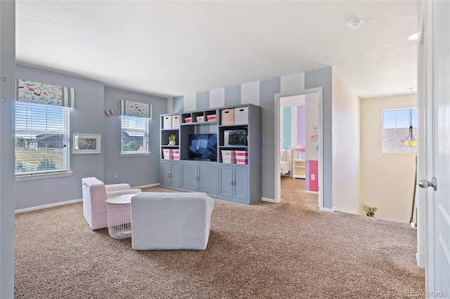 carpeted living room featuring baseboards