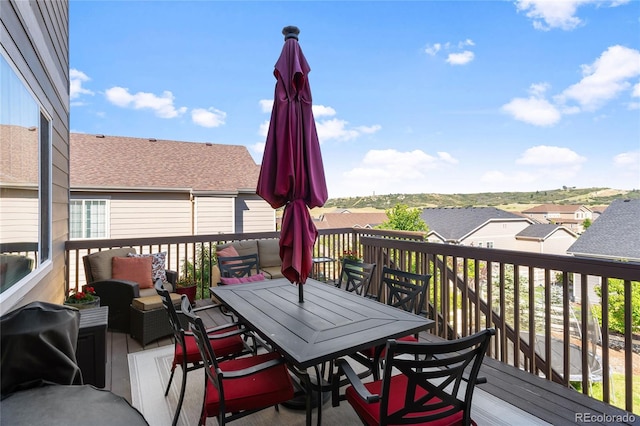 deck featuring a residential view and outdoor dining area