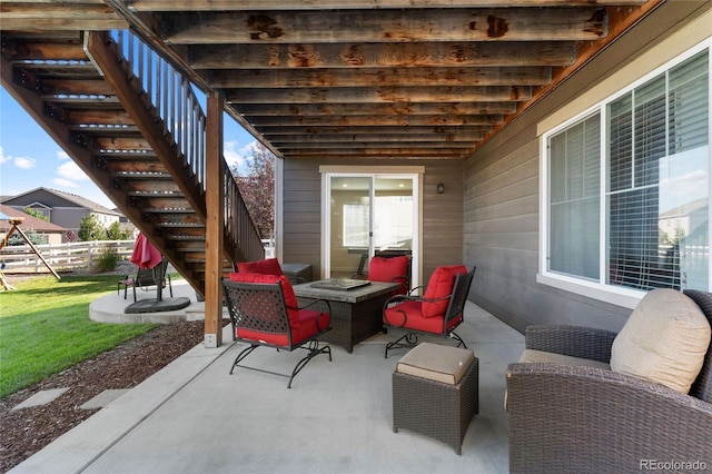 view of patio featuring an outdoor hangout area, stairs, and fence