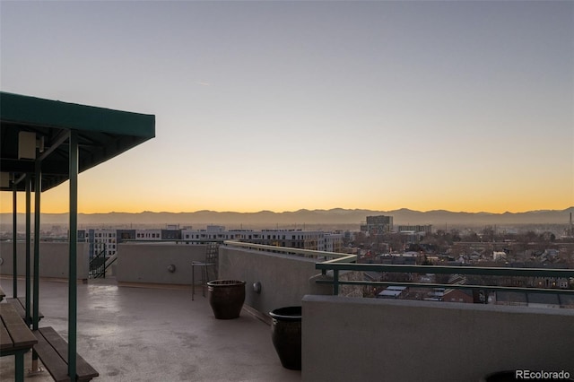 601 W 11th Ave Unit 910, Denver, CO 80204 - patio terrace at dusk featuring a mountain view and a balcony