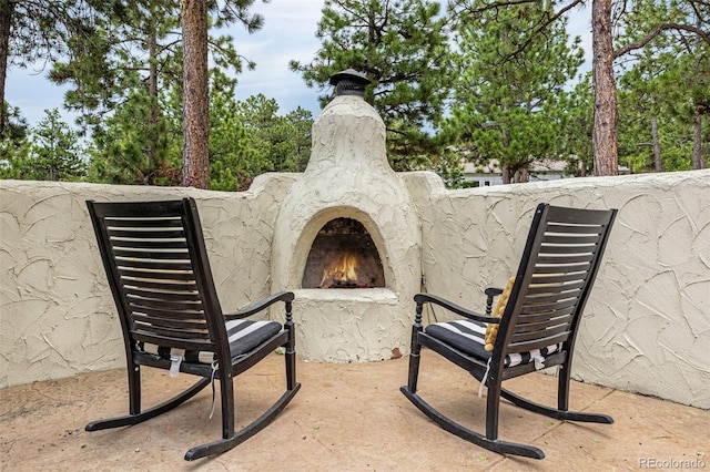 17995 Minglewood Trl, Monument, CO 80132 - view of patio with a lit fireplace