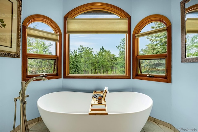 17995 Minglewood Trl, Monument, CO 80132 - full bathroom with tile patterned floors, a freestanding tub, and healthy amount of natural light
