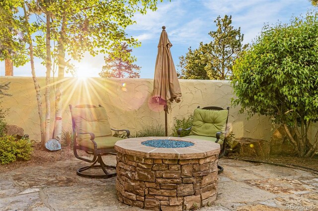 17995 Minglewood Trl, Monument, CO 80132 - fenced backyard with a fire pit and a patio area