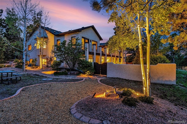17995 Minglewood Trl, Monument, CO 80132 - back of property at dusk featuring stucco siding