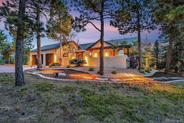 17995 Minglewood Trl, Monument, CO 80132 - back of property featuring stucco siding, a garage, and concrete driveway