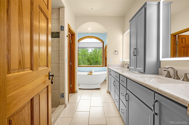 17995 Minglewood Trl, Monument, CO 80132 - full bath with double vanity, tile patterned flooring, a soaking tub, and a stall shower