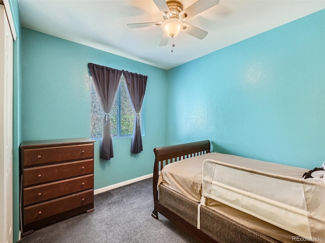 bedroom with ceiling fan and dark carpet