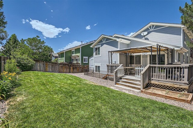 back of house featuring a yard and a deck