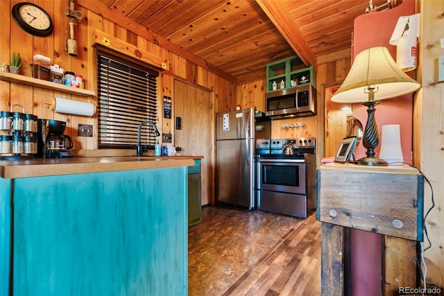 kitchen with appliances with stainless steel finishes, wooden walls, wood ceiling, and sink