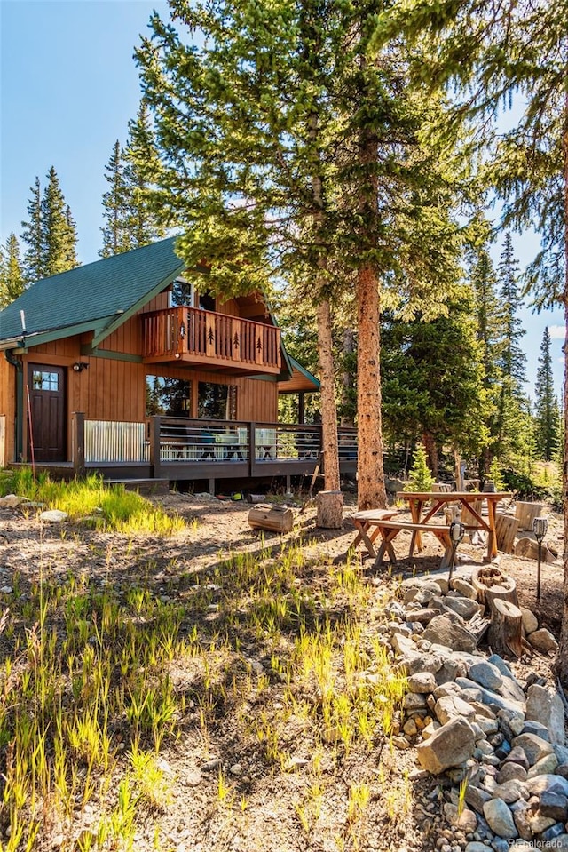 back of house with a wooden deck