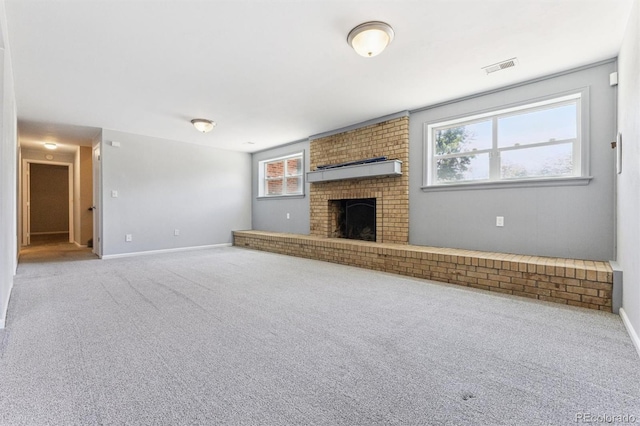 11815 E Louisiana Ave, Aurora, CO 80012 - unfurnished living room featuring carpet, plenty of natural light, and a fireplace