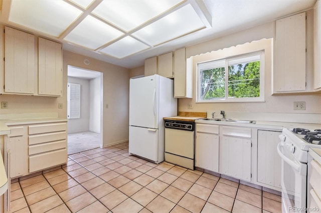11815 E Louisiana Ave, Aurora, CO 80012 - kitchen featuring white appliances, light countertops, and light tile patterned floors