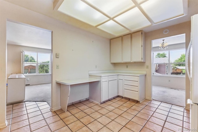 11815 E Louisiana Ave, Aurora, CO 80012 - kitchen featuring light colored carpet, light countertops, light tile patterned floors, and freestanding refrigerator