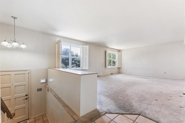 11815 E Louisiana Ave, Aurora, CO 80012 - carpeted spare room featuring a chandelier and tile patterned flooring