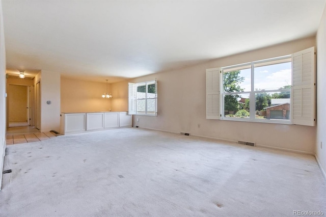 11815 E Louisiana Ave, Aurora, CO 80012 - carpeted empty room featuring a chandelier and baseboards