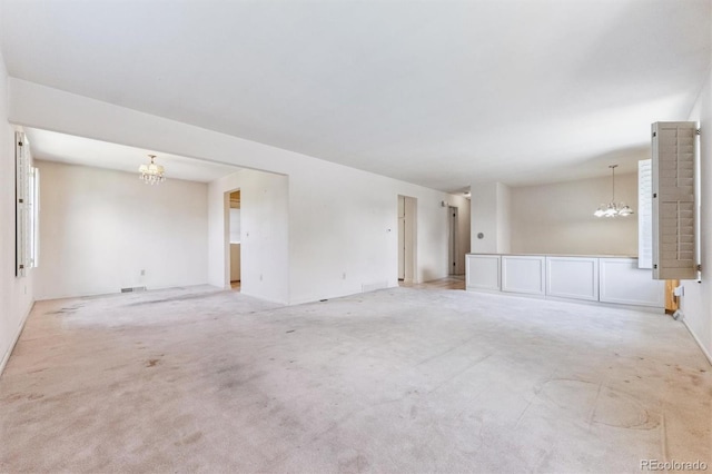 11815 E Louisiana Ave, Aurora, CO 80012 - empty room featuring a chandelier and light carpet