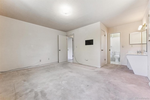 11815 E Louisiana Ave, Aurora, CO 80012 - unfurnished bedroom featuring light carpet and connected bathroom