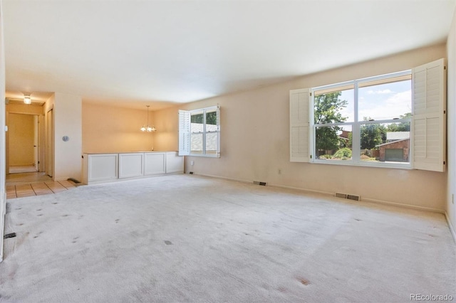 11815 E Louisiana Ave, Aurora, CO 80012 - carpeted spare room featuring a chandelier and baseboards