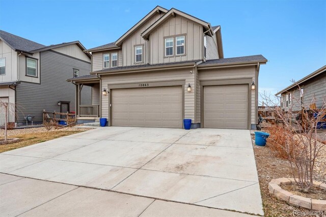 view of front of house featuring concrete driveway, a garage, and board and batten siding