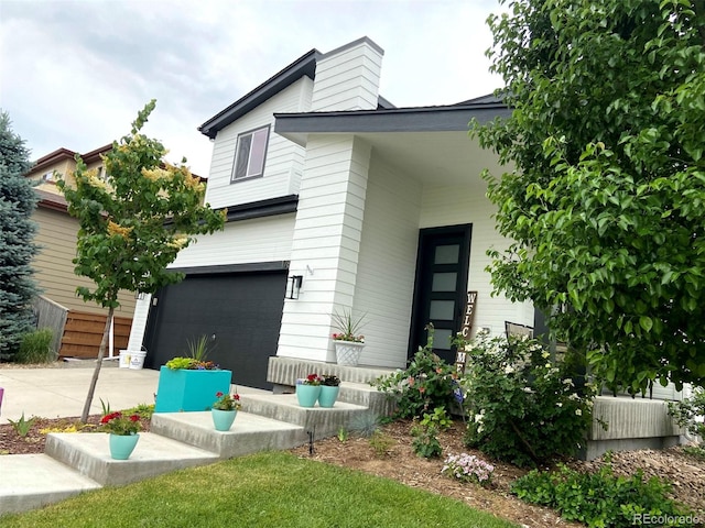 rear view of property with a garage