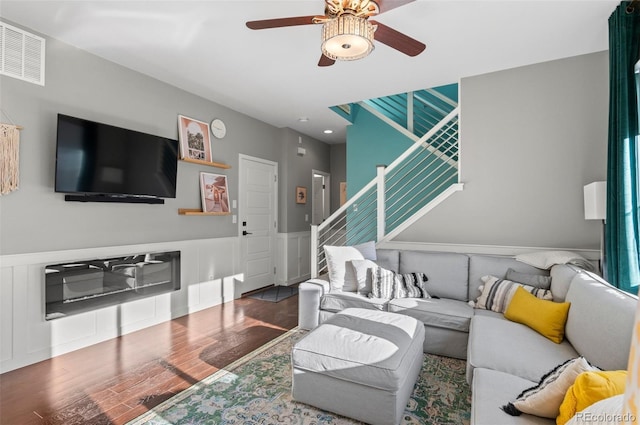 living room with hardwood / wood-style flooring and ceiling fan