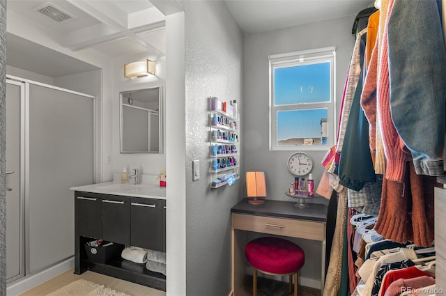 bathroom with walk in shower and vanity