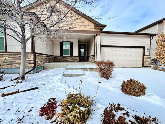 view of front of property featuring stone siding and an attached garage