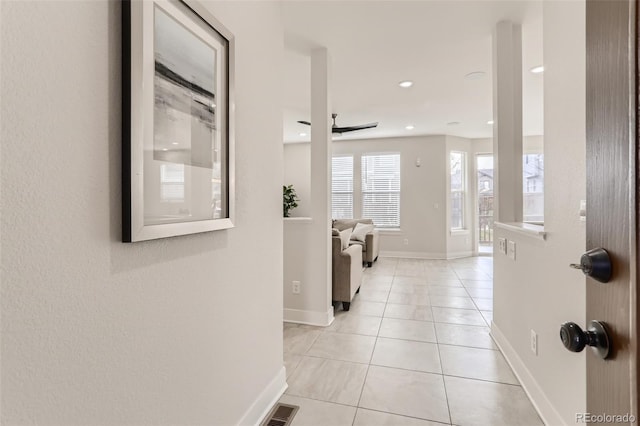 hall with recessed lighting, visible vents, baseboards, and light tile patterned floors