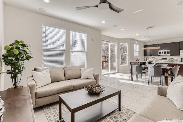 living area with a ceiling fan, recessed lighting, and light tile patterned flooring