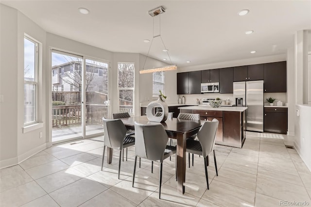 dining area featuring recessed lighting, baseboards, and light tile patterned floors