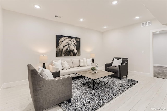 living area featuring recessed lighting and visible vents