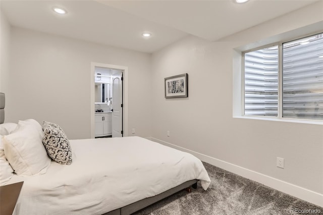 carpeted bedroom featuring ensuite bath, baseboards, and recessed lighting