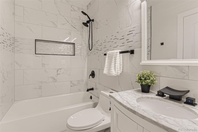 bathroom with tile walls, backsplash, toilet, washtub / shower combination, and vanity