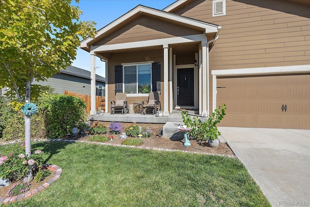view of front of property with a porch, a front yard, concrete driveway, and an attached garage