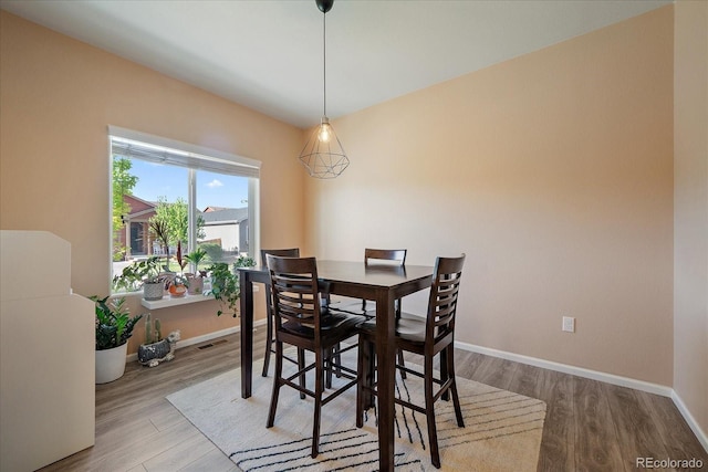 dining area featuring wood finished floors and baseboards