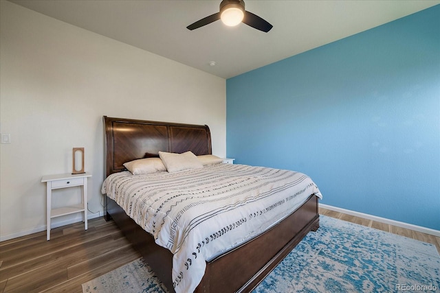 bedroom with wood finished floors, baseboards, and a ceiling fan