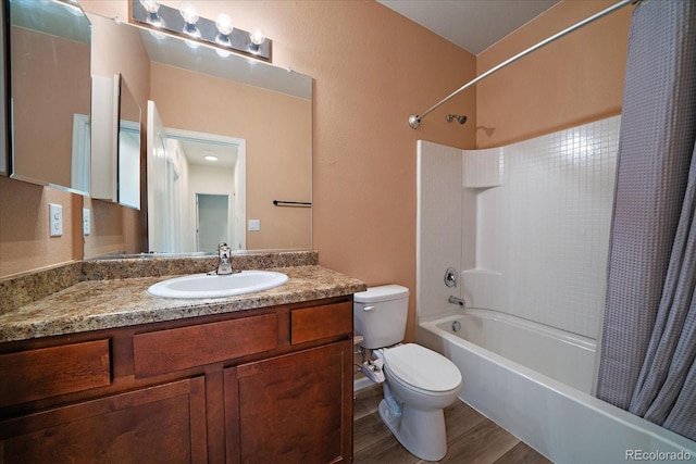full bathroom featuring toilet, shower / tub combo with curtain, wood finished floors, and vanity