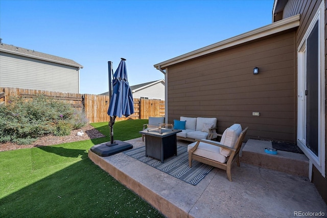 view of patio with an outdoor living space with a fire pit