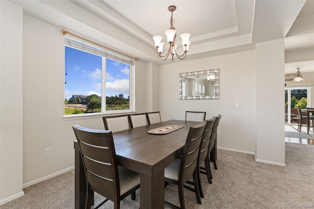 12978 Newport Way, Thornton, CO 80602 - dining area featuring a chandelier, carpet floors, and a raised ceiling
